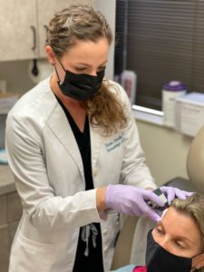 Dr. Karen Connolly works with a patient.