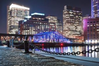 Boston Harbor and Financial District at night in Boston, Massachusetts.